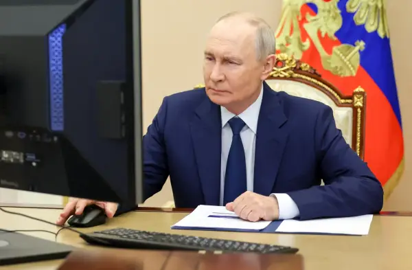 In this pool photograph distributed by the Russian state agency Sputnik, Russia's President Vladimir Putin votes online in the parliamentary election in Moscow on September 18, 2026. (Photo by Vyacheslav PROKOFYEV / POOL / AFP via Getty Images)
